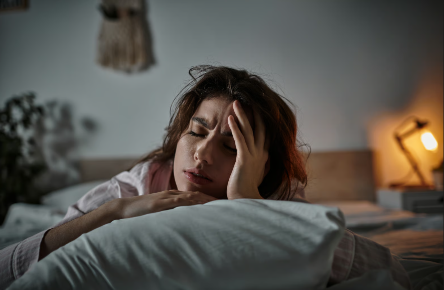 Woman lying in bed exhausted after a full night of sleep
