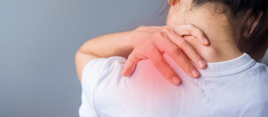 A person experiencing chronic neck pain and tension, illustrating the stress-pain cycle.
