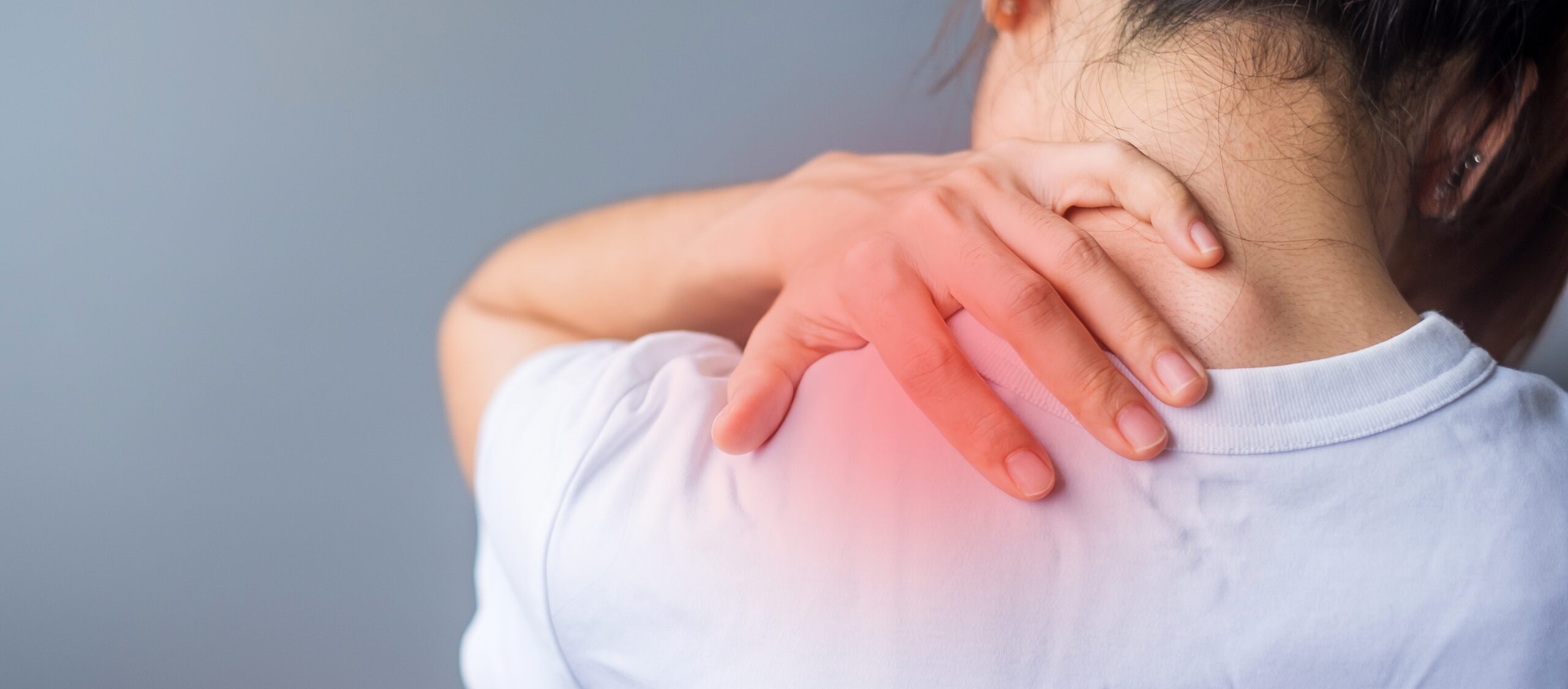 A person experiencing chronic neck pain and tension, illustrating the stress-pain cycle.